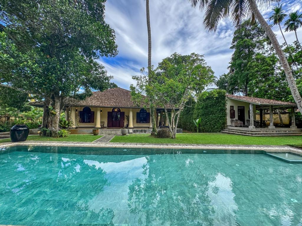 an empty swimming pool in front of a house at Heenatigala Walawwa - Free Shuttle to Our Private Beach in Talpe