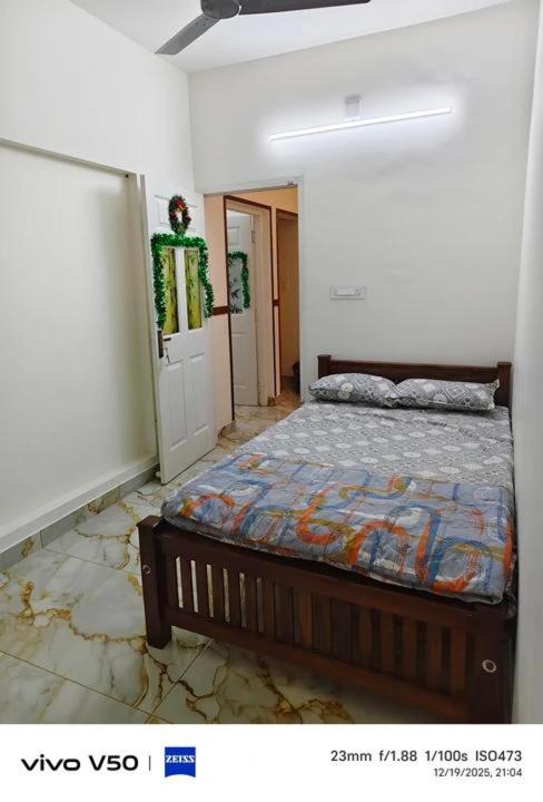 a bedroom with a bed in a room at JOHNs' Paradise - Homestay in Cochin