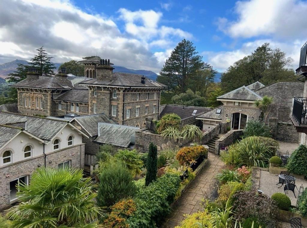 a large mansion with a garden in front of it at Underscar - Luxury 2 Bed Apartment in Keswick