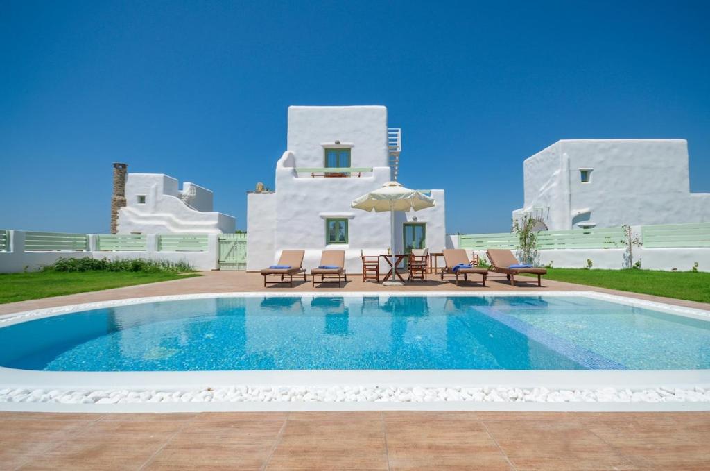 a swimming pool in front of a villa at My Villa Naxos in Naxos Chora