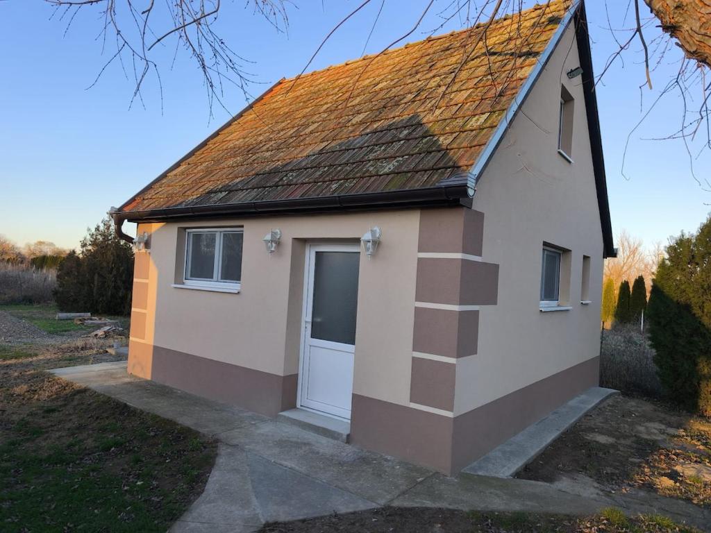 a small house with a door and a roof at Little Village Loft in Káty