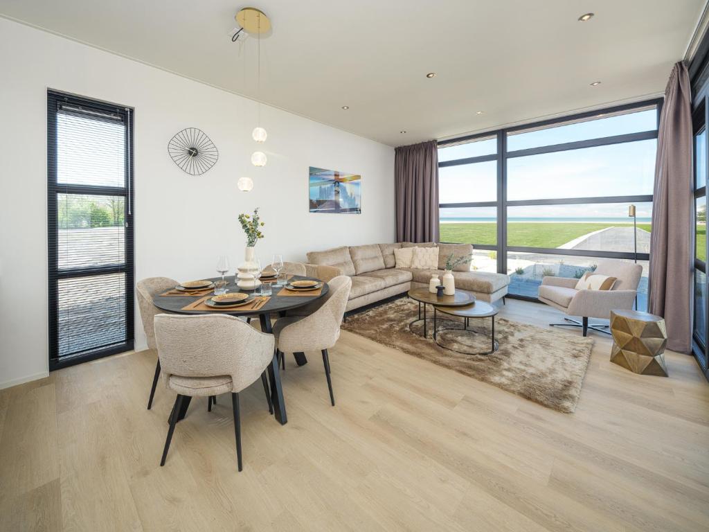 a living room with a table and a couch at Villa L-Meerzicht | 4 pers. in Workum