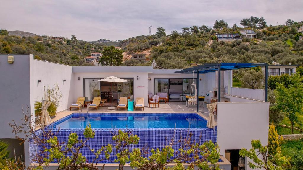 a villa with a swimming pool and a house at VillA Esin in Kaş
