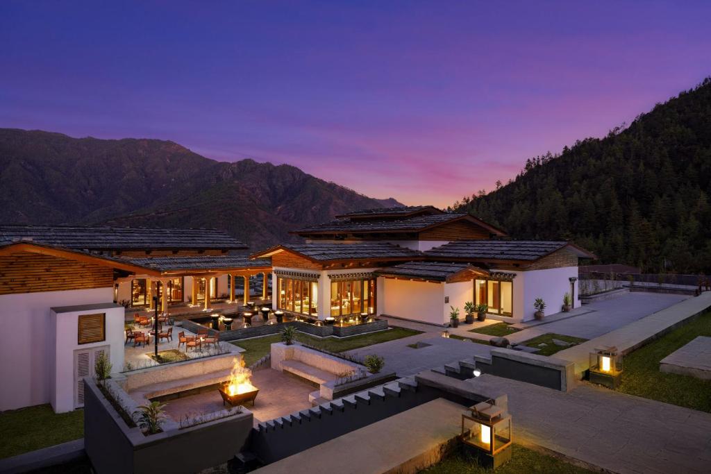 an aerial view of a house with mountains in the background at Taj Paro Resort & Spa in Paro