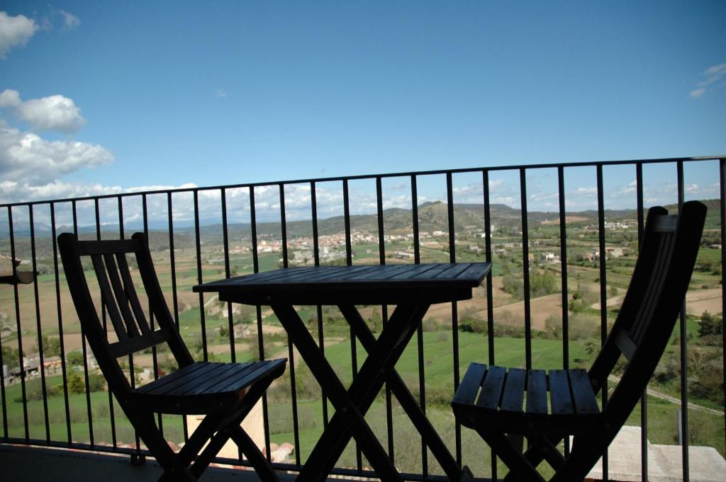 a table and two chairs on a balcony with a view at La Sabina in Montsonis