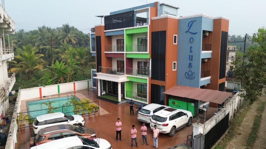 a building with cars parked in front of it at Lotus Beach Resort in Nagaon