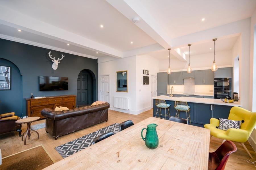 a living room with a couch and a table at The Leiston, High Street in Leiston