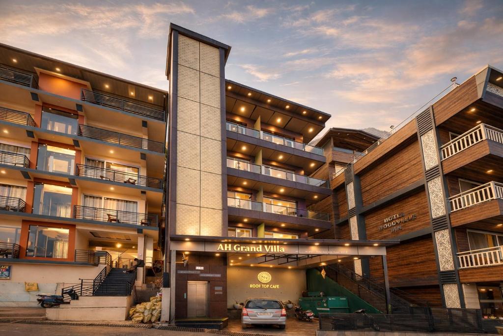 an apartment building with a car parked in front of it at AH Grand Villa - Hotel Near Dalai Lama Temple in McLeod Ganj