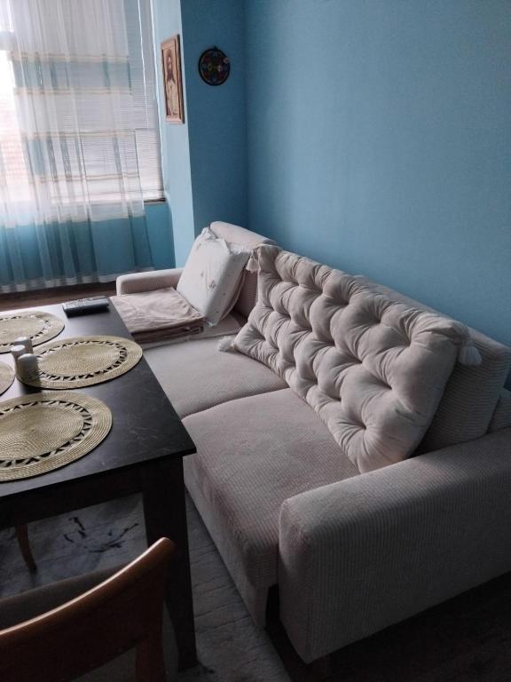 a living room with a couch and a table at Апартамент център Поли in Sandanski