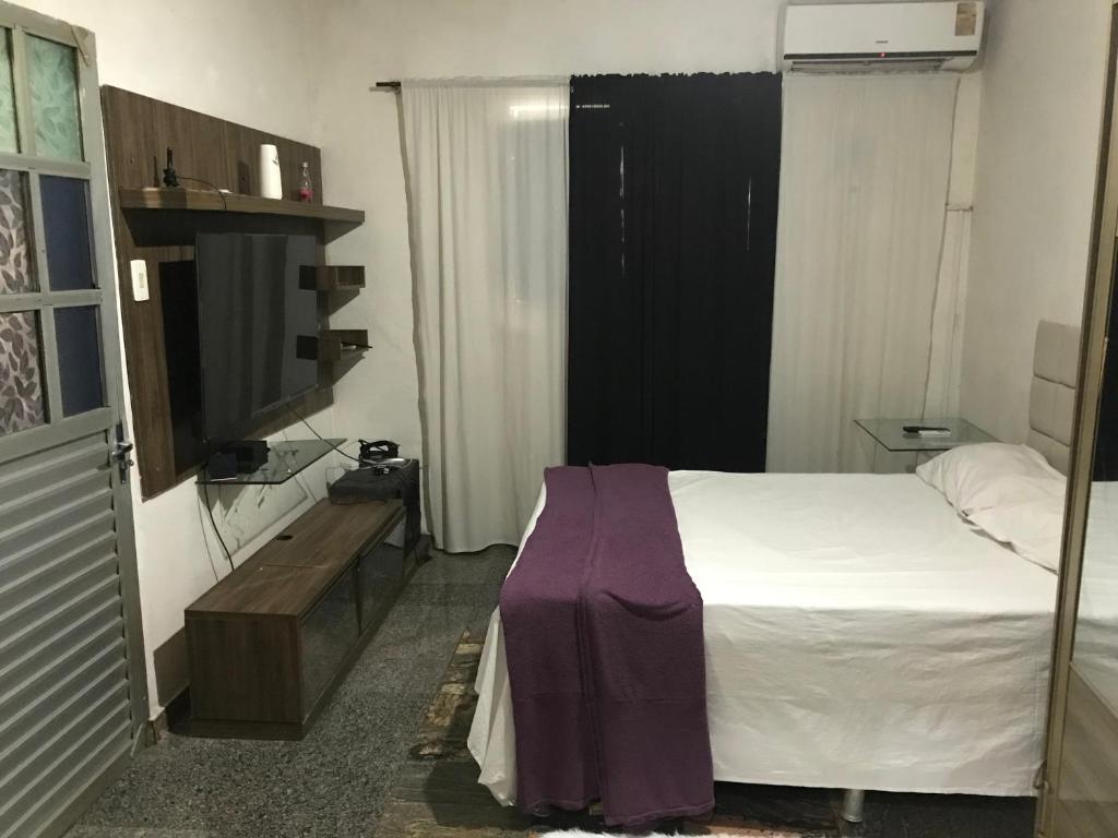 a small bedroom with a bed and a tv at casa boa vista in Recife