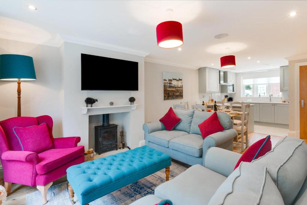 a living room with a couch and chairs and a tv at 3 Bed in Helmsley oc-y111 in Helmsley