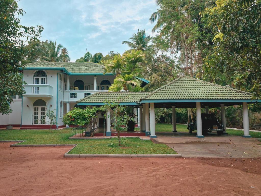 a house with a gazebo in front of it at Villa House in Miriswatta
