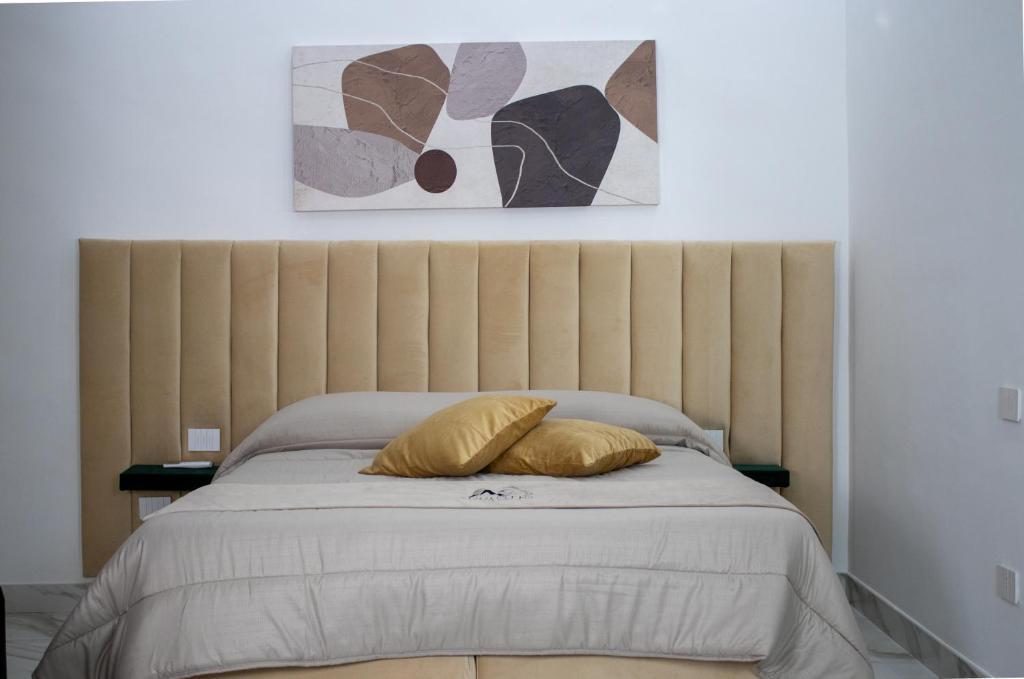 a bedroom with a bed with two pillows on it at Augustea Travel Rooms in Frignano