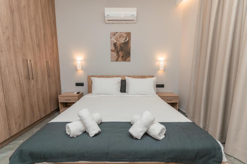 a bedroom with a large white bed with two pillows at Aurora 3 - Family Comfort near the beach in Marmari