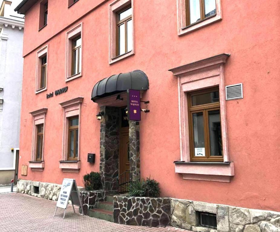 a red building with a sign in front of it at DAEGA with daehan in Žilina