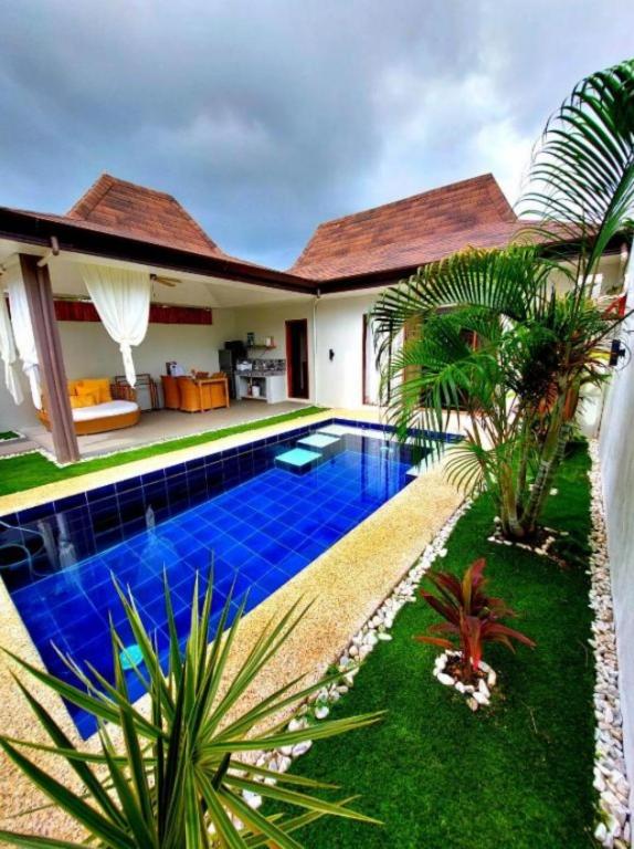 a swimming pool in the backyard of a house at Bali Villas Panglao Bohol in Panglao Island