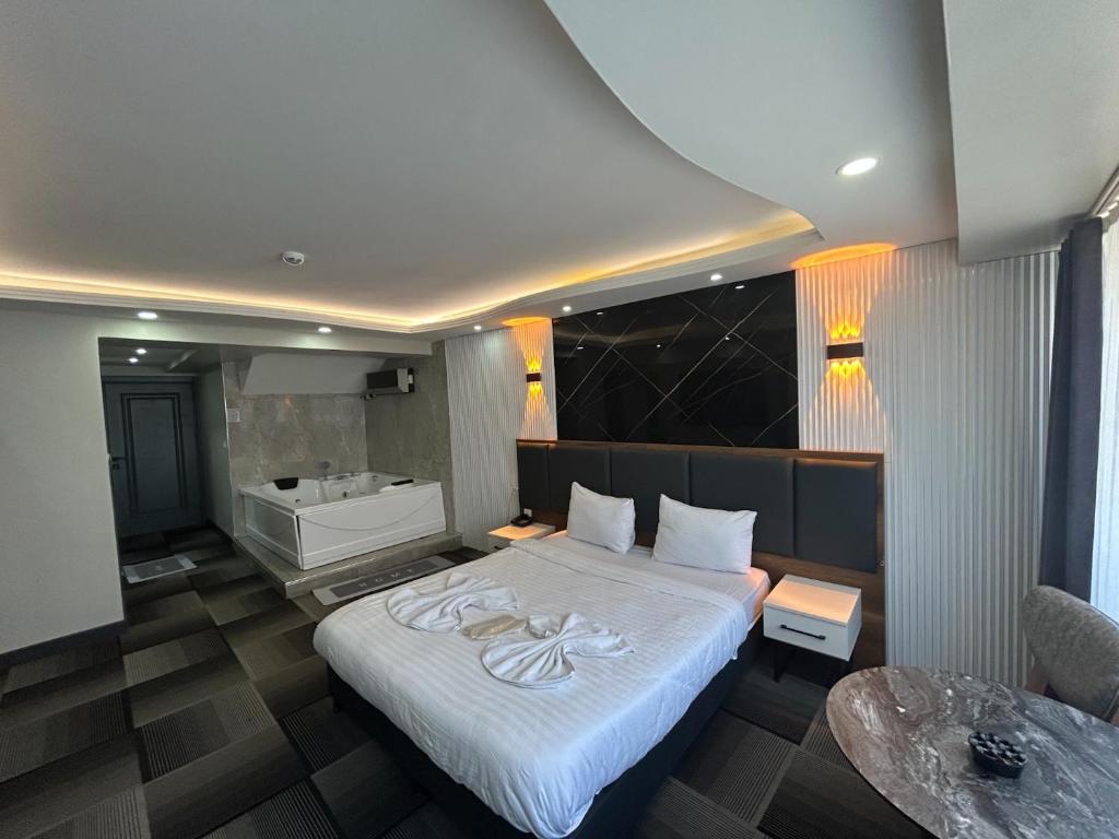 a bedroom with a bed and a bath tub at Lizbonia Suit Otel in Istanbul