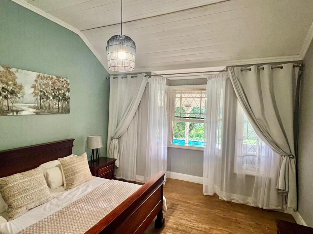 a bedroom with a bed and a window at Briar & Bloom2 in Hilton