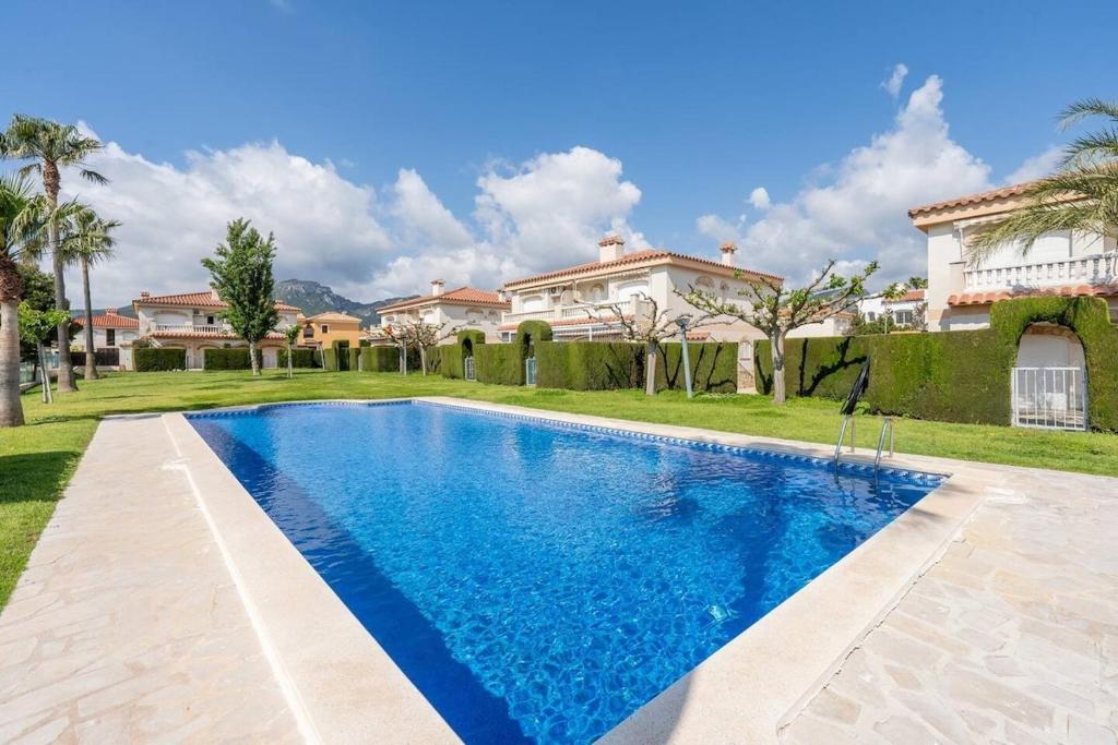 a swimming pool in front of a house at Brisa I Apartment in Montroig