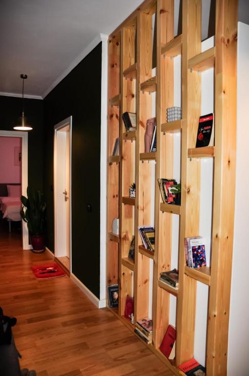 a room with a wall of wooden shelves at Ilia's Coastal Apartement in Vlorë