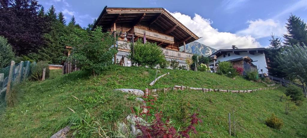 a house on top of a grassy hill at Chalet Edelweiß in Achenkirch