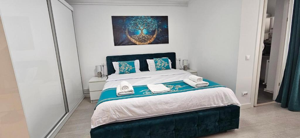 a bedroom with a bed and a painting on the wall at Mady STUDIO in Hunedoara