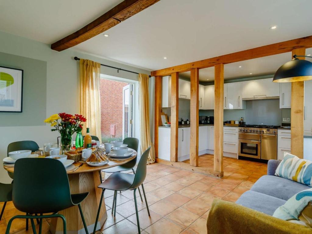a kitchen and living room with a table and a couch at 3 Bed in Saxmundham oc-89691 in Aldringham