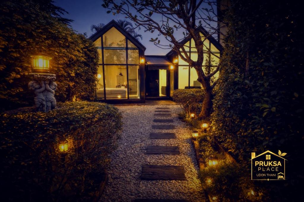 a pathway leading to a house at night with lights at Pruksa Place Udon Thani in Udon Thani