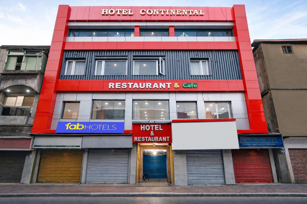 a red and white building with a sign in front at FabHotel Continental in kolkata