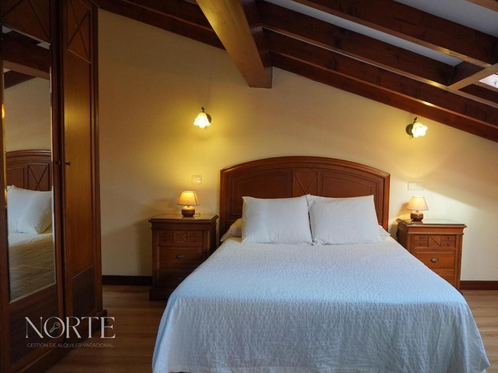 a bedroom with a large bed with two night stands at Casa Mayra in Camargo