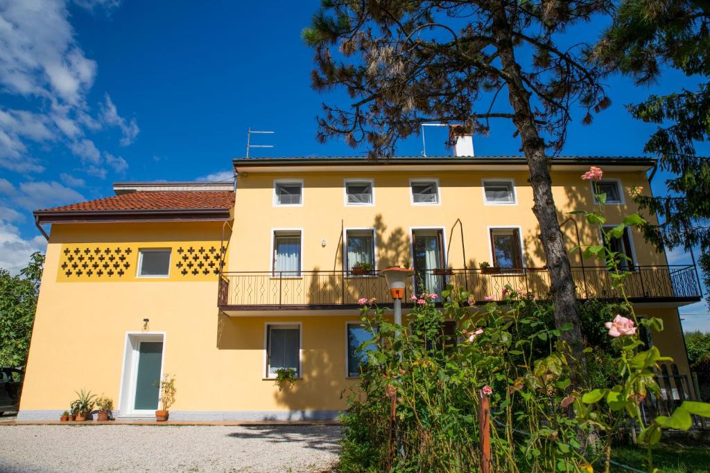 a large yellow building with a balcony at Casa dei Nonni in Mirabella
