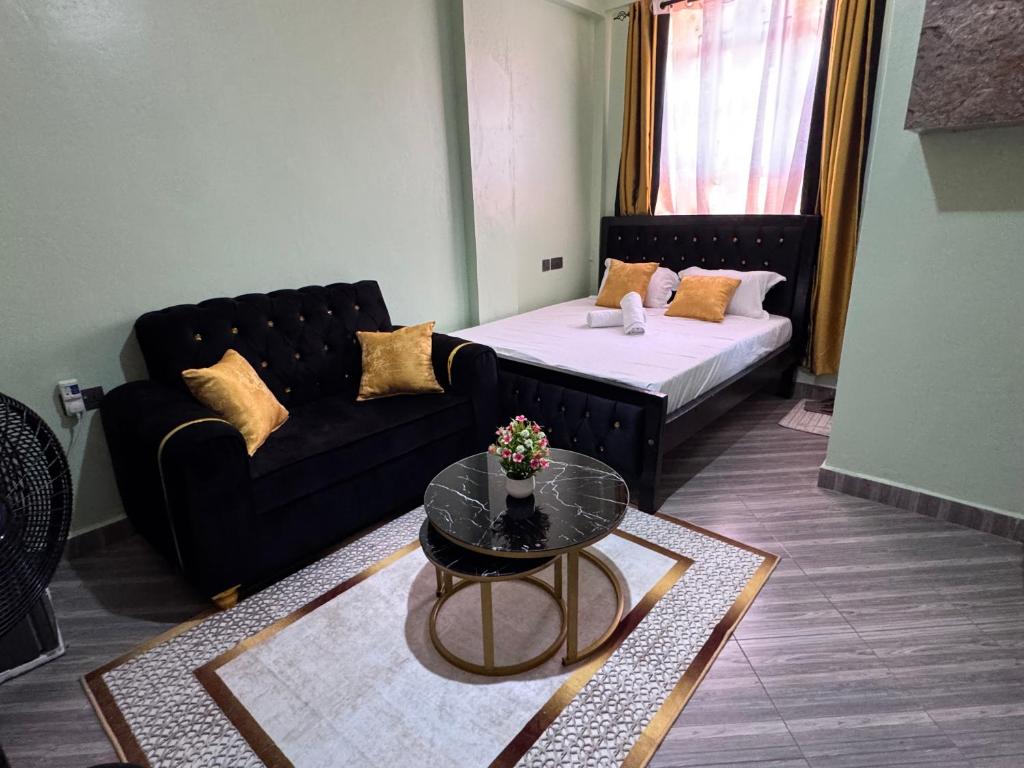 a living room with a couch and a table at H lacasa in Voi