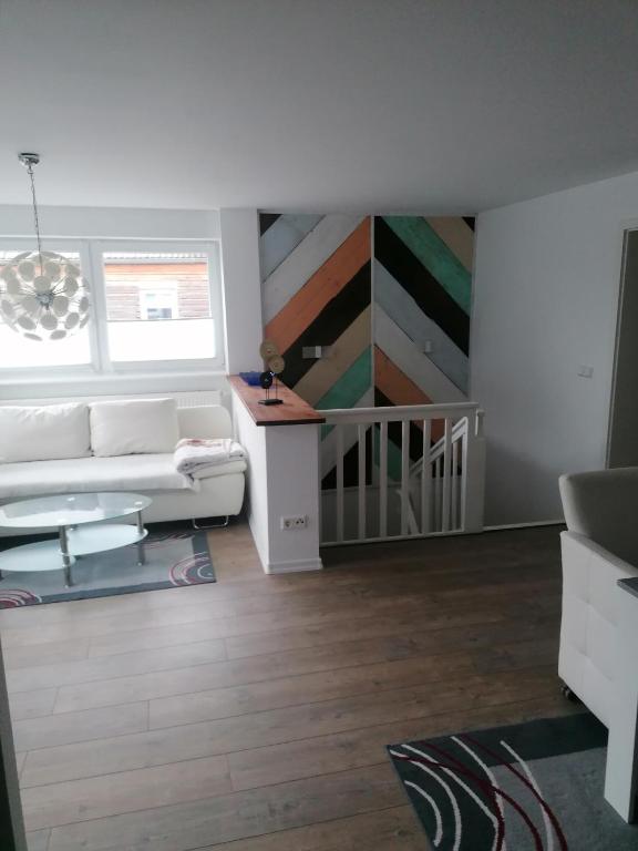a living room with a couch and a painting on the wall at Tinas Fewo 2 in Hohendodeleben