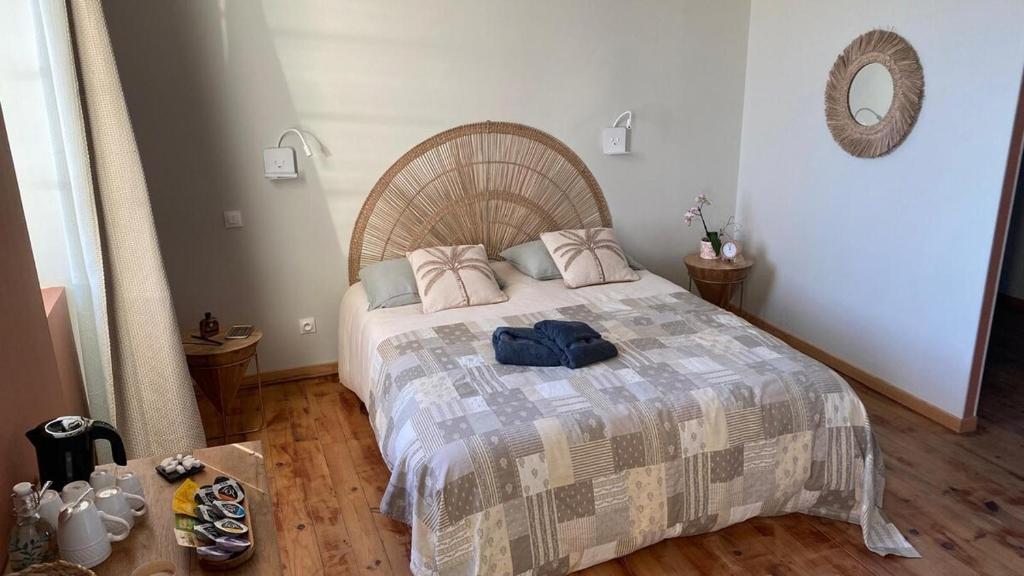 a bedroom with a large bed with a wooden floor at Chambre Terracotta privée et accès jacuzzi - sauna in Lézat-sur-Lèze