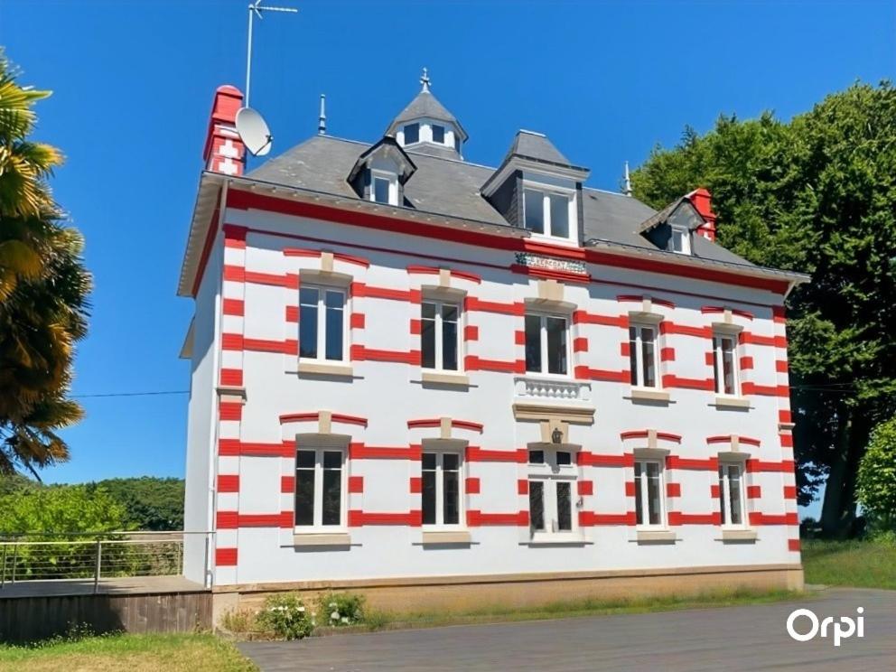 a large white building with red and white stripes at REF 495 Quéven type 7 manor house in Quéven