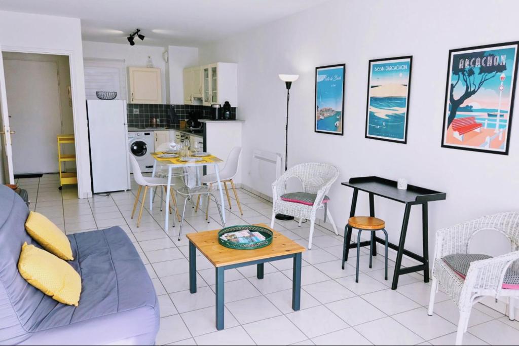 a living room with a couch and a table at Spacious apartment in La Teste-de-Buch in La Teste-de-Buch