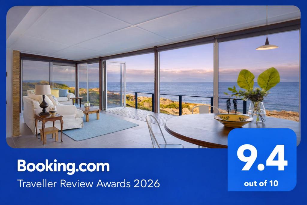 a room with a view of the ocean at Rocky Bay on the View in Gordonʼs Bay