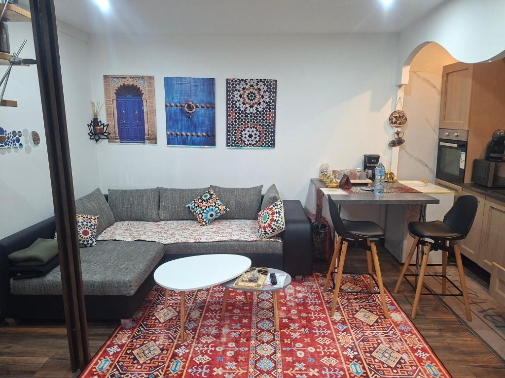 a living room with a couch and a table at Lille Flandre duplex in Lille