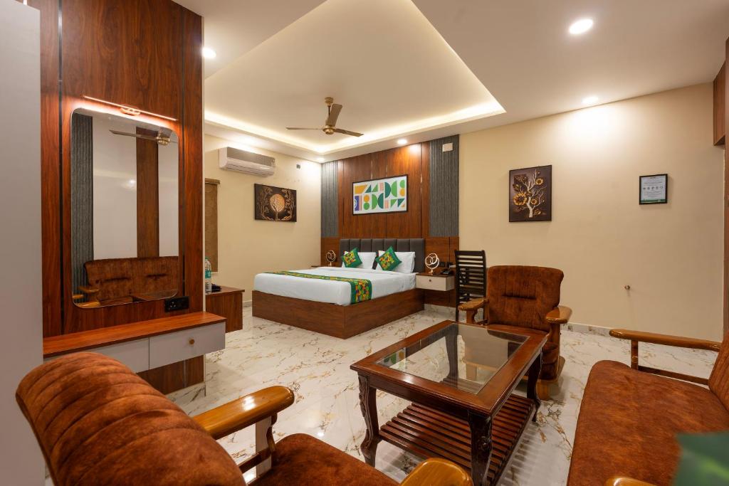 a hotel room with a bed and a living room at Treebo Sri Anand Residency in Chennai