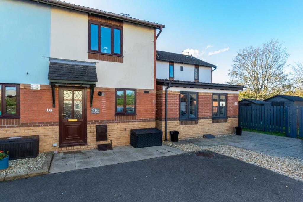 a brick house with a driveway in front of it at 2 Bed in Newton oc-bow124 in Porthcawl