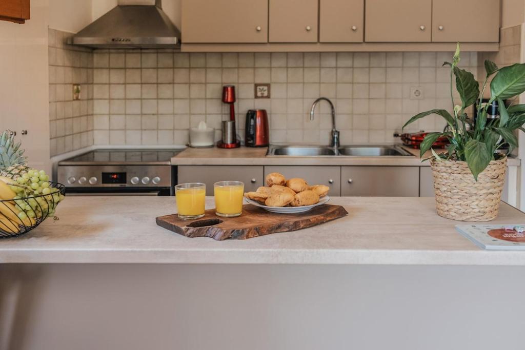 a kitchen counter with two glasses of orange juice at Casa Dentraki in Corfu