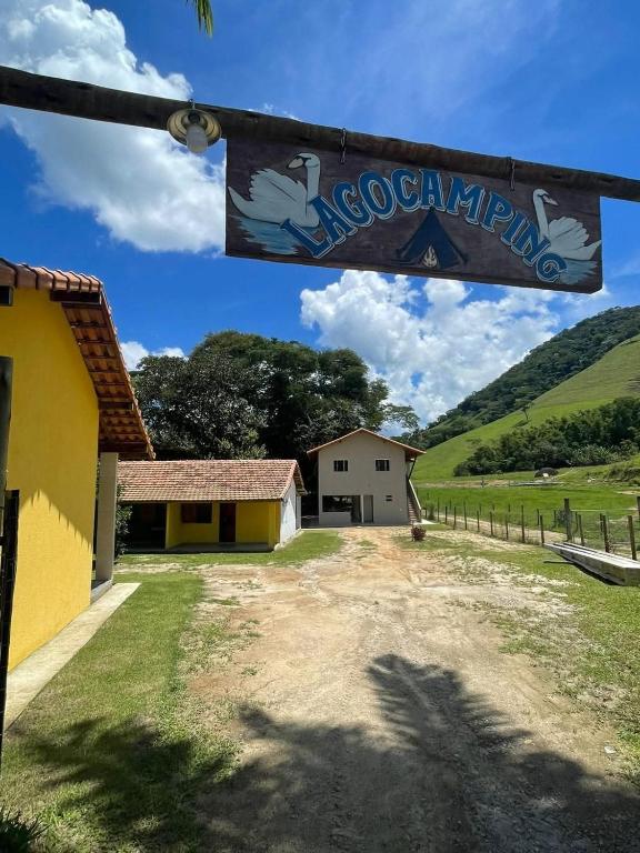 a view of a house with a sign in front of it at Lago Camping Sana in Macaé
