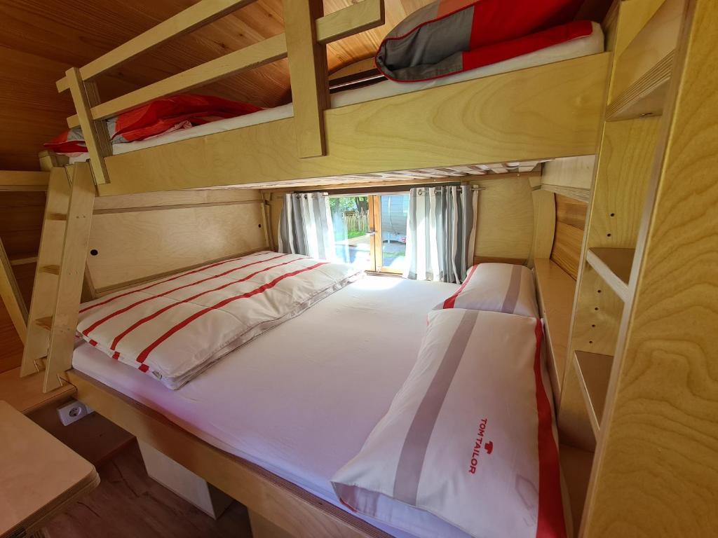 a small room with a bed and bunk beds at Schlaffässer am Haus der Schmetterlinge in Uslar