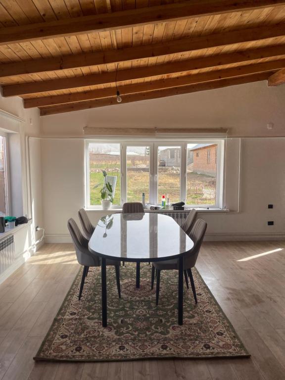 a dining room with a table and chairs at Guest house Sayak in Bokonbayevo