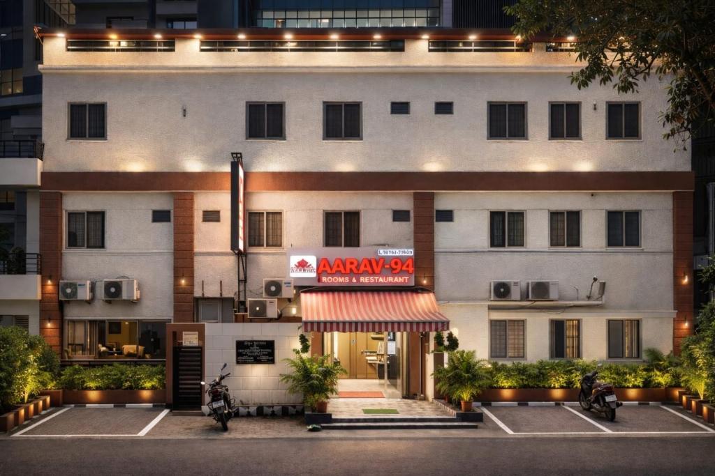 a large white building with a sign in front of it at Hotel YO94 in Indore