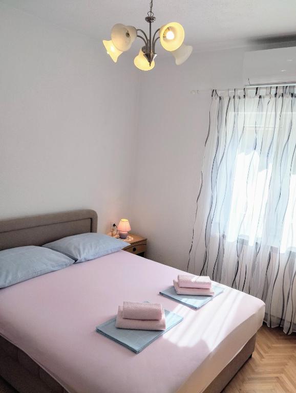 a bedroom with a bed with two towels on it at Room Rosa in Senj