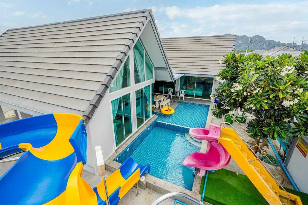 a swimming pool with a slide and a water park at Tripple P Pool Villa ชะอำ in Cha Am