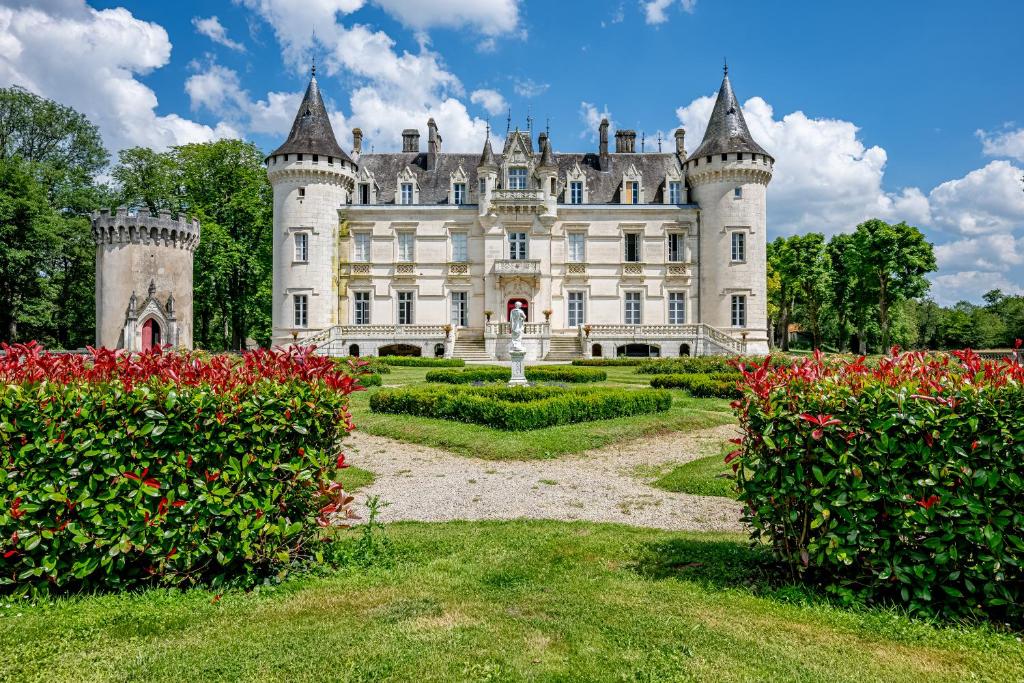 an old castle with a garden in front of it at Château Optical Center in Nieuil