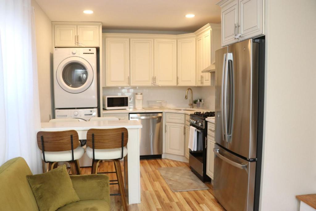 a kitchen with a refrigerator and a table and chairs at An Apartment for You to Relax - B in Uniondale