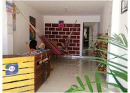 a room with a staircase and a brick wall at Hostal Santa Maria City in Santa Marta
